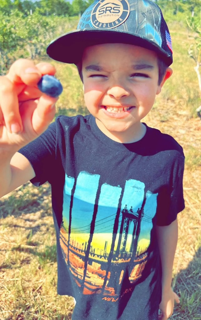 Boy Proud of Blueberry He Picked